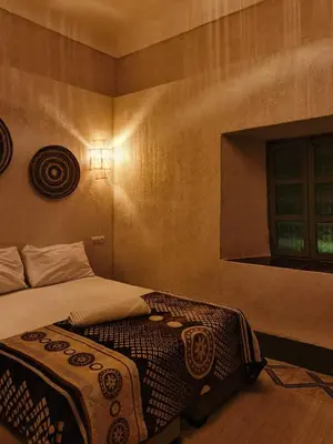 a bedroom with a bed and a window at Medina Oasis Hostel in Marrakech
