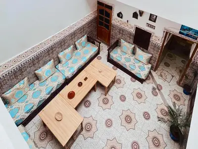 an overhead view of a living room with a table and chairs at Medina Oasis Hostel in Marrakech
