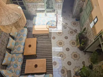 an overhead view of a living room with a couch and tables at Medina Oasis Hostel in Marrakech