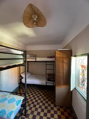 a room with bunk beds and a ceiling fan at Medina Oasis Hostel in Marrakech