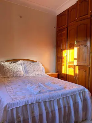 a bedroom with a bed with a blue comforter at Calm Cosy Villa in Marrakech