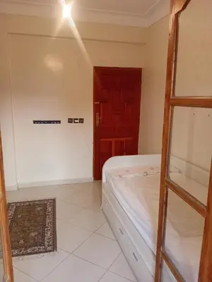 a bedroom with a bed and a wooden door at Calm Cosy Villa in Marrakech