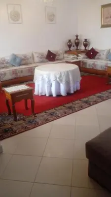 a living room with a table and a couch at Calm Cosy Villa in Marrakech