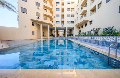 a swimming pool in the middle of a building at appartement 3 chambres avec piscine in Marrakech