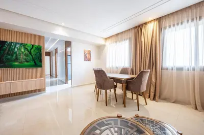 a dining room with a table and chairs at appartement 3 chambres avec piscine in Marrakech