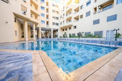 a swimming pool in front of a building at appartement 3 chambres avec piscine in Marrakech