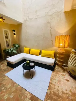a living room with a couch and a table at Riad Fiora, private home!!! in Marrakech