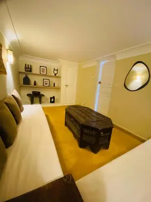 a bedroom with a large bed and a table at Riad Fiora, private home!!! in Marrakech