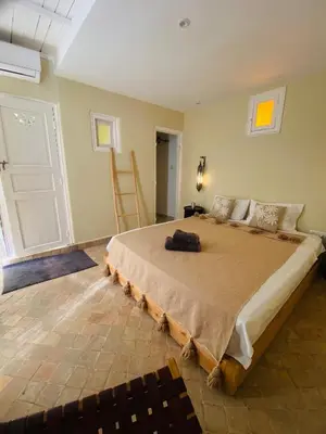 a bedroom with a large bed in a room at Riad Fiora, private home!!! in Marrakech