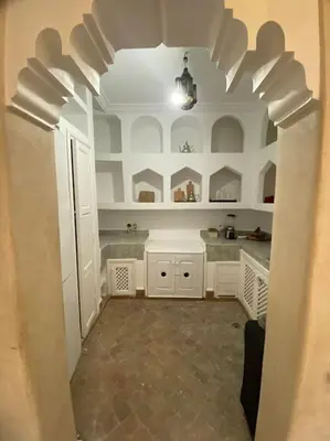 a large kitchen with white cabinets and a ceiling at Riad Fiora, private home!!! in Marrakech