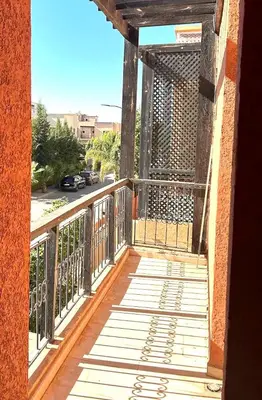 a balcony with a metal railing and a view of a street at Villa targa marrakech in Marrakech