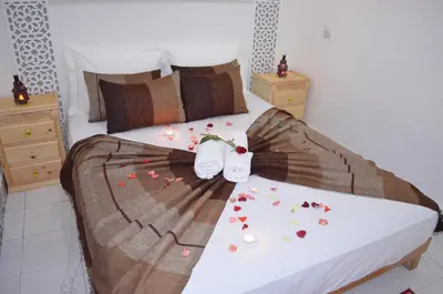 a bedroom with a bed with flowers on it at Al Bahja family in Marrakech