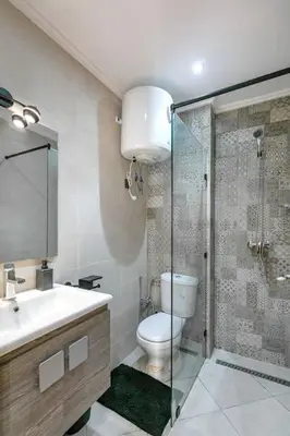 a bathroom with a toilet and a glass shower at RA26 Elegant&Chaleureux Netflix et parking gratuit in Marrakech
