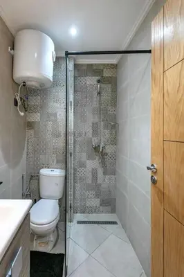 a bathroom with a toilet and a glass shower at RA26 Elegant&Chaleureux Netflix et parking gratuit in Marrakech