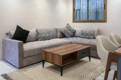 a living room with a couch and a coffee table at Red City Rendezvous – Downtown in Marrakech