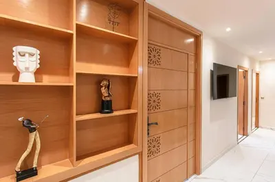 a room with wooden shelves and a door at Red City Rendezvous – Downtown in Marrakech