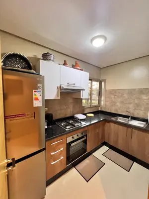a kitchen with a stainless steel refrigerator and a sink at Golf stay with Atlas view at Marrakech! in Marrakech