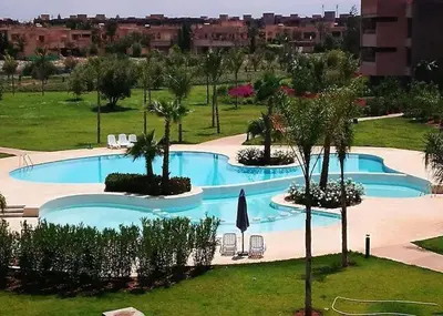 an overhead view of a swimming pool in a resort at Golf stay with Atlas view at Marrakech! in Marrakech
