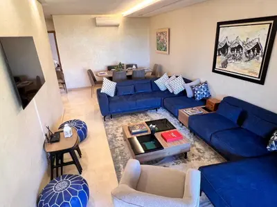 an overhead view of a living room with blue couches at Golf stay with Atlas view at Marrakech! in Marrakech