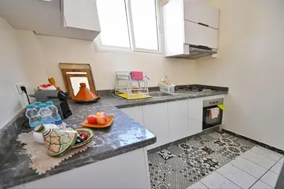 a kitchen with a counter with a bowl of fruit on it at Tigami in Marrakech