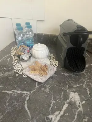 a counter with bottles of water and a plate of food at Tigami in Marrakech