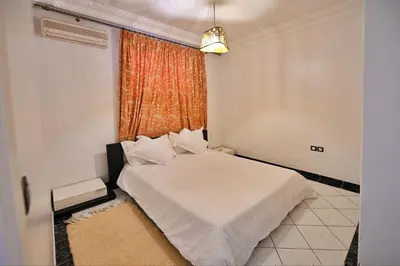 a bedroom with a white bed and a window at Tigami in Marrakech