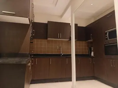 a kitchen with brown cabinets and a sink at Appartement Bayt Atik in Marrakech