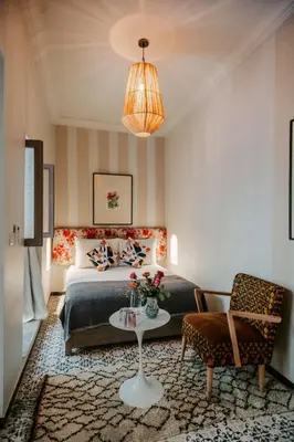 a bedroom with a bed and a table and a chair at Riad VUE D'AGDAL in Marrakech
