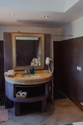 a bathroom with a sink and a mirror at Riad VUE D'AGDAL in Marrakech