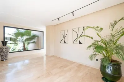 a living room with a plant in a vase at Villa Hicham Golf Marrakech in Marrakech