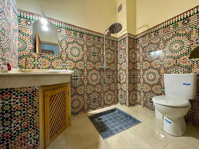 a bathroom with a toilet and a sink at Riad Flottement Des Songes in Marrakech