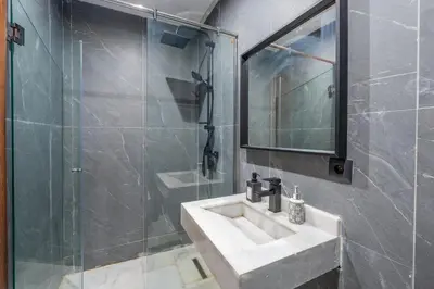 a bathroom with a sink and a glass shower at Beau Studio au hub de Gueliz in Marrakech