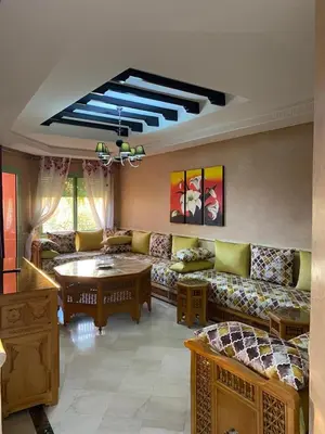 a living room with a couch and a table at Cosy Appartement Avec Piscine in Marrakech