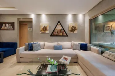 a living room with a couch and a table at Poolside Apartment's-Green View in Marrakech