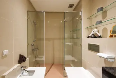 a bathroom with a glass shower and a sink at Poolside Apartment's-Green View in Marrakech