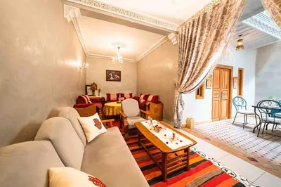 a living room with a couch and a table at Riad Kiyanjana in Marrakech