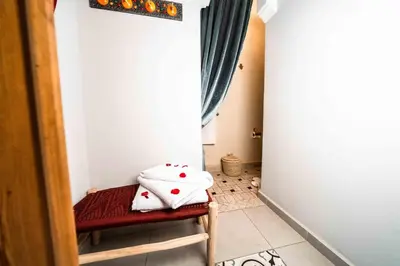 a hallway with a table with pillows on it at Riad Kiyanjana in Marrakech