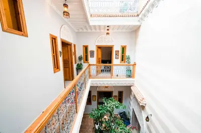 a hallway of a building with stairs and plants at Riad Kiyanjana in Marrakech