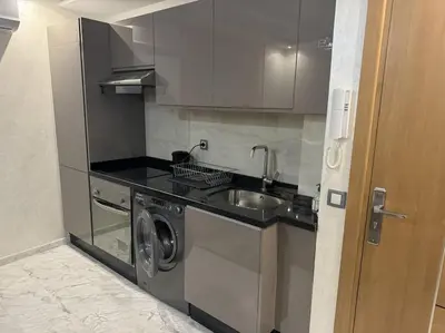 a kitchen with a sink and a washing machine at appartement à Gueliz in Marrakech