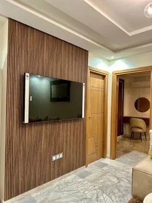 a hotel room with a flat screen tv on a wall at appartement à Gueliz in Marrakech