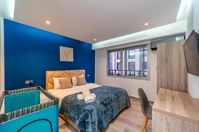 a blue bedroom with a bed and a desk at Luxury studio Center Gueliz in Marrakech