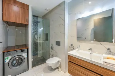 a bathroom with a sink and a washing machine at Luxury studio Center Gueliz in Marrakech