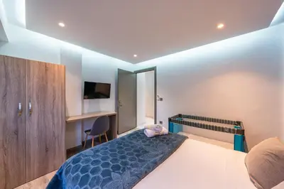 a bedroom with a bed and a desk and a bed sidx sidx sidx at Luxury studio Center Gueliz in Marrakech