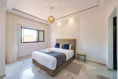 a bedroom with a large bed and a window at Luxury Place M Avenue in Marrakech