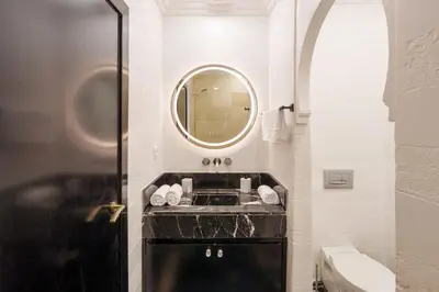 a bathroom with a black sink and a mirror at Luxury Place M Avenue in Marrakech
