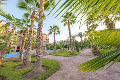 a resort with palm trees and a swimming pool at Luxury Place M Avenue in Marrakech