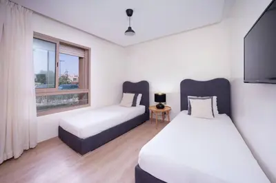 a bedroom with two beds and a window at Relax Front Of Pool-Golf-Atlas in Marrakech