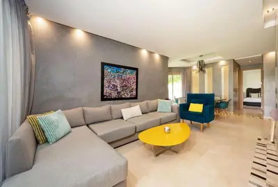 a living room with a couch and a table at Relax Front Of Pool-Golf-Atlas in Marrakech