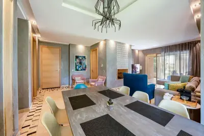 a living room with a dining table and chairs at Relax Front Of Pool-Golf-Atlas in Marrakech