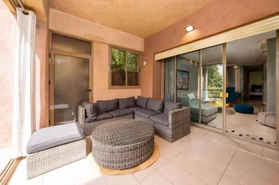 a living room with a couch and a table at Relax Front Of Pool-Golf-Atlas in Marrakech